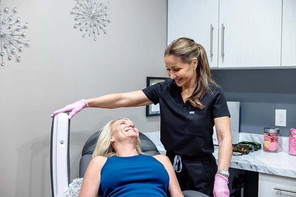Woman receiving treatment from a smiling professional.