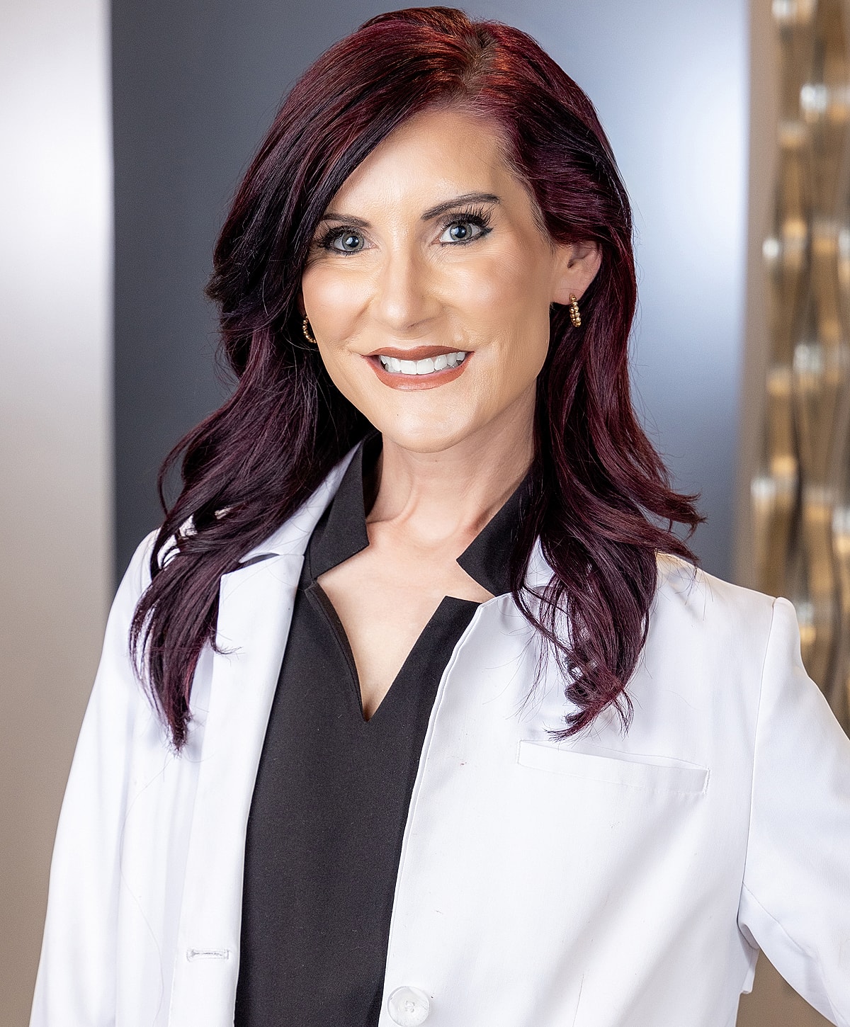 Smiling woman in a lab coat.