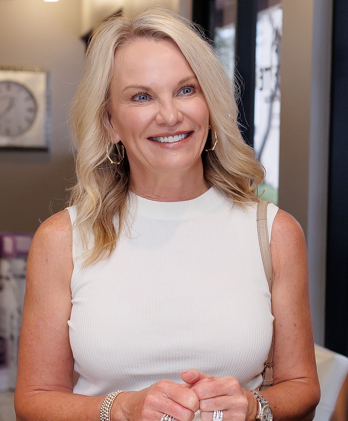 Smiling woman in a modern, stylish setting.