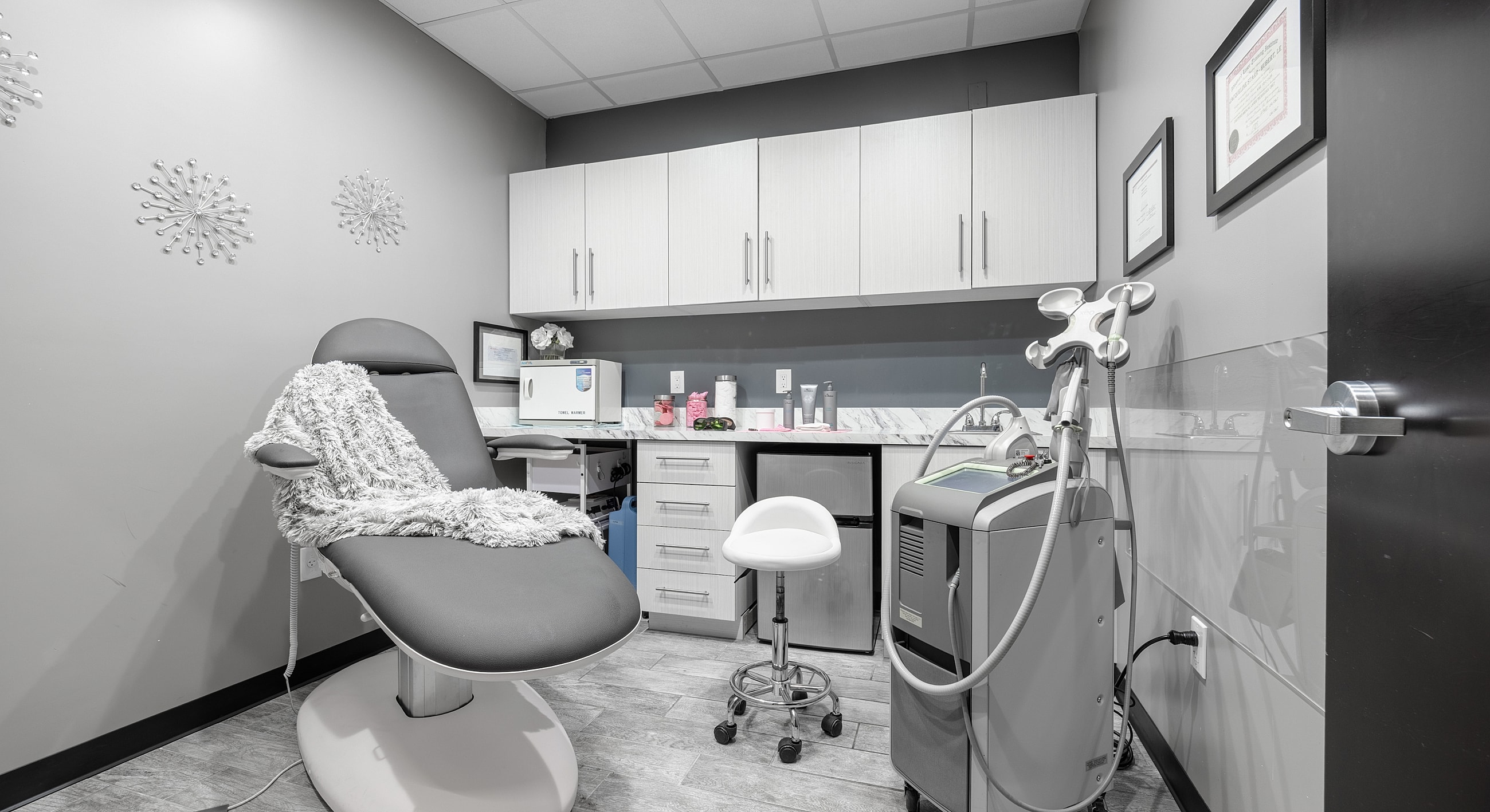 Modern aesthetic treatment room with medical equipment.