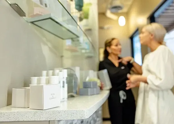 Spa consultation with skincare products displayed.